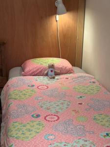 a teddy bear sitting on top of a bed at Bed & Breakfast 28 Appartement met Privé Tuin in Assen