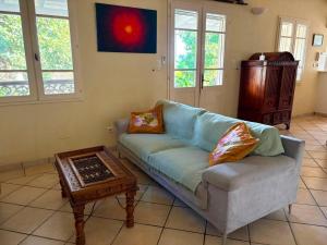a living room with a couch and a coffee table at La maison du Ruisseau in Saint-Louis