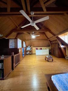 a large room with a ceiling fan and a bedroom at La maison du Ruisseau in Saint-Louis +47 photos