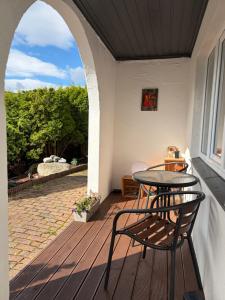 a patio with a table and chairs on a porch at Sukkertoppen Apartment in Ålesund