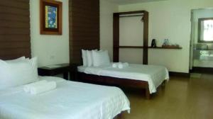 a hotel room with two beds and a mirror at Pineapple Island Resort in Badas +249 photos