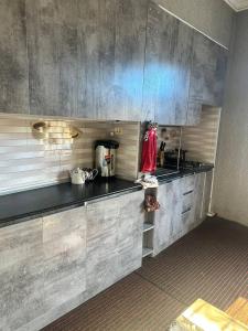 a kitchen with a sink and a counter top at JOMIY Guest House in Margilan +41 photos