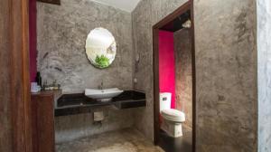 a bathroom with a sink and a toilet at Chababaancham Resort in Amphawa