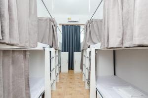 a row of beds in a room with curtains at Garden Hostel 16 in Yerevan