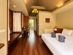 a bedroom with a large white bed and a table at Flow Hua Hin - Ice Bath and Villa in Hua Hin