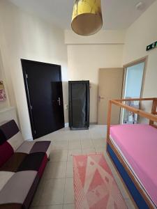 a room with two beds and a black door at Sunset View Maisonette, Kanali in Néa Thésis