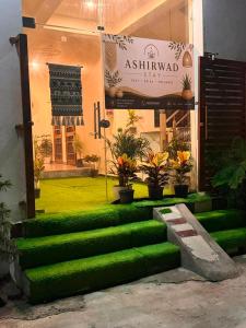 a green set of stairs in front of a building at Ashirwad Stay in Rishīkesh