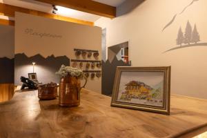 a wooden table with a picture of a house on it at Mont Velan Chambres & Restaurant in Saint-Oyen