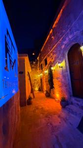 an alley with a building at night with lights at Terrace Merdin Konagı in Mardin