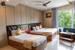 a hotel room with two beds and a window at Hotel Runway Inn in Pura Raghunāth +61 photos