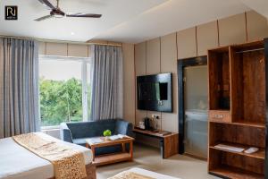 a hotel room with a bed and a tv at Hotel Runway Inn in Pura Raghunāth