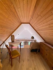 a room with a table and a bed in a attic at Apartment with a view in Upflamör in Zwiefalten