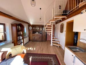 a kitchen with a spiral staircase in a house at Apartment with a view in Upflamör in Zwiefalten