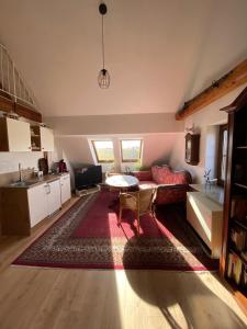 a living room with a red couch and a table at Apartment with a view in Upflamör in Zwiefalten +3 photos