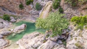 an aerial view of a river in a canyon at La Villa de Madeleine - Stone Villa with outdoor hot tub in Arcadia, Peloponnese in Áyios Ioánnis
