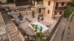 an overhead view of a house with a patio and a pool at La Villa de Madeleine - Stone Villa with outdoor hot tub in Arcadia, Peloponnese in Áyios Ioánnis