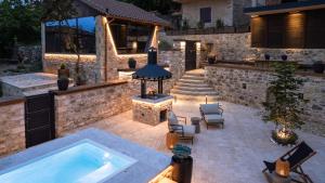 a backyard with a swimming pool and a house at La Villa de Madeleine - Stone Villa with outdoor hot tub in Arcadia, Peloponnese in Áyios Ioánnis +47 photos