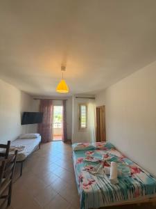 a bedroom with a bed and a table in it at A&A Aparthotel in Orikum