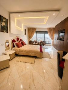 a large bedroom with a large bed and a table at Chez Roberto in La Marsa
