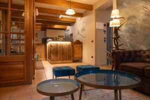 a living room with two tables and a couch at Mont Velan Chambres & Restaurant in Saint-Oyen