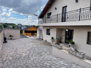 an empty courtyard of a house with a balcony at Casa Aylin in Corbu