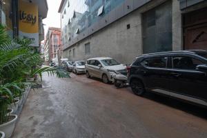 a row of parked cars parked on a city street at Itsy Hotels Riya Near IGI Airport in New Delhi