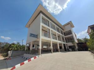 a large white building with a lot of windows at Lynn Living (ลินน์ ลิฟวิ่ง) in Ban Non Muang