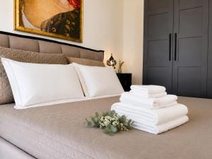 a pile of towels sitting on top of a bed at Borgo Carla in Massa