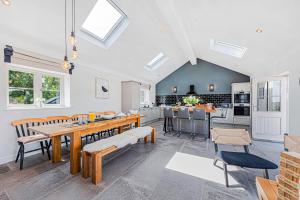 a kitchen and dining room with a table and chairs at Fairvale House in Northwich