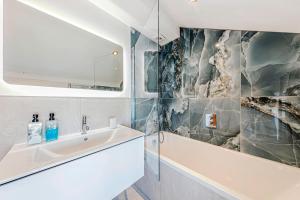 a bathroom with a sink and a bath tub at Fairvale House in Northwich +52 photos