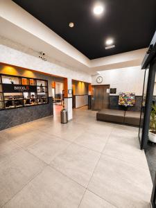 a lobby with a waiting area with a clock on the wall at Brxxl 5 City Centre Hostel in Brussels +42 photos