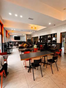 a restaurant with tables and chairs in a room at Brxxl 5 City Centre Hostel in Brussels