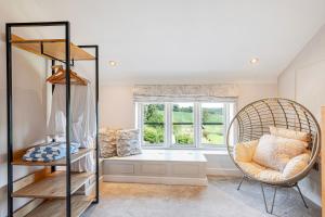 a room with a window and a chair and a window seat at Fairvale House in Northwich
