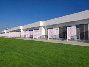 a building with a green lawn in front of it at Evita Flamingo in Kos