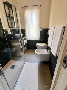 a bathroom with a toilet and a sink at Borgo Carla in Massa +8 photos