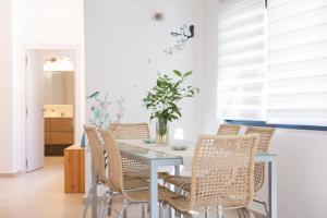 a dining room with a table and chairs at Villa Amoudia - Luxury Villa right on the beach with Private Pool in Sivota