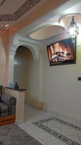 a living room with a flat screen tv on the wall at appartement Airport Guests Marrakech in Marrakesh