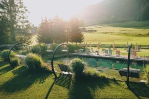 a park with a bench and a swimming pool at CORE Kaprun in Kaprun