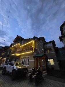 a white truck parked in front of a building at Lime Tree Haven in Kulu +4 photos