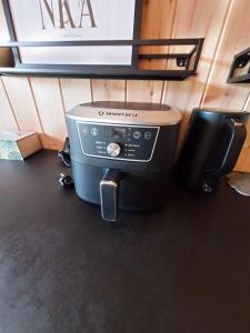 a printer sitting on the floor in a room at Na Kocankach - Domki na wyłączność in Czarnoszyce