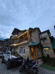 a couple of motorcycles parked in front of a building at Lime Tree Haven in Kulu