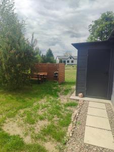 a backyard with a picnic table and a shed at Na Kocankach - Domki na wyłączność in Czarnoszyce +73 photos
