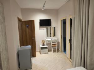 a living room with a television on the wall at Hotel Natali 2 in Dhërmi