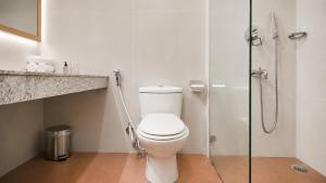 a bathroom with a toilet and a glass shower at Mount Himalayan Hotel in Gangtok +44 photos