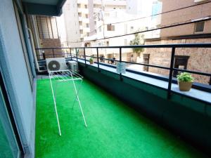 a green and white tennis court with a tennis racket at Osaka Guesthouse HIVE in Osaka