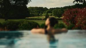 a woman in a swimming pool in a garden at Rockliffe in Darlington