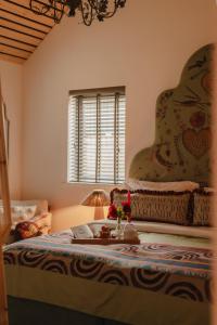 a bedroom with a bed with a lamp on it at Gorgeous Stylish Home Near Longleat and Bath with Private Heated Pool and Sauna in Corsley