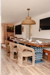a dining room with a table and some chairs at Gorgeous Stylish Home Near Longleat and Bath with Private Heated Pool and Sauna in Corsley