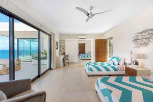 a bedroom with two beds and a view of the ocean at Villa with exclusive views in Marigot +29 photos