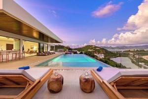 a villa with a swimming pool and a house at Villa with exclusive views in Marigot